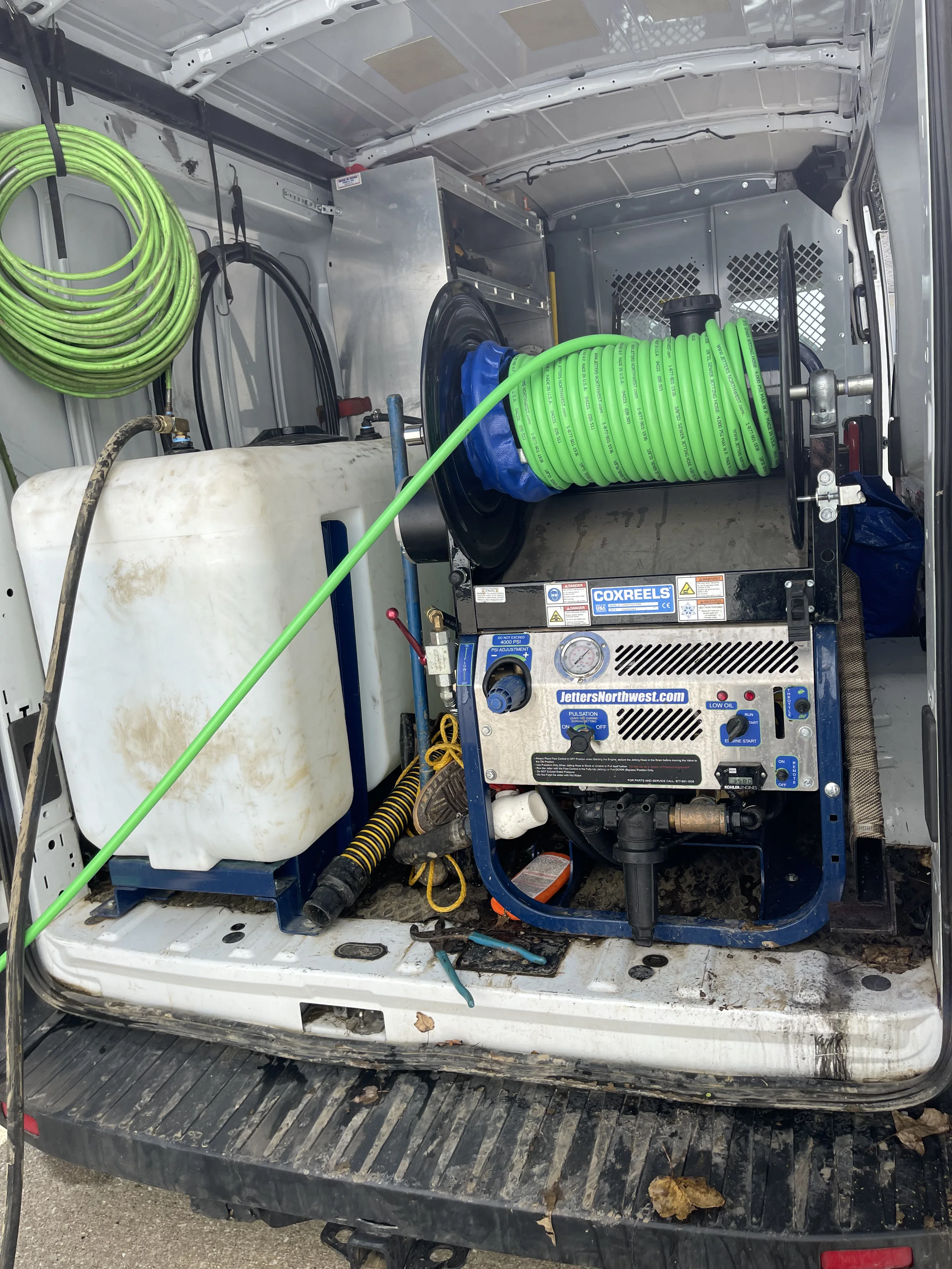Professional plumber performing drain cleaning and sewer maintenance in Wooster, OH