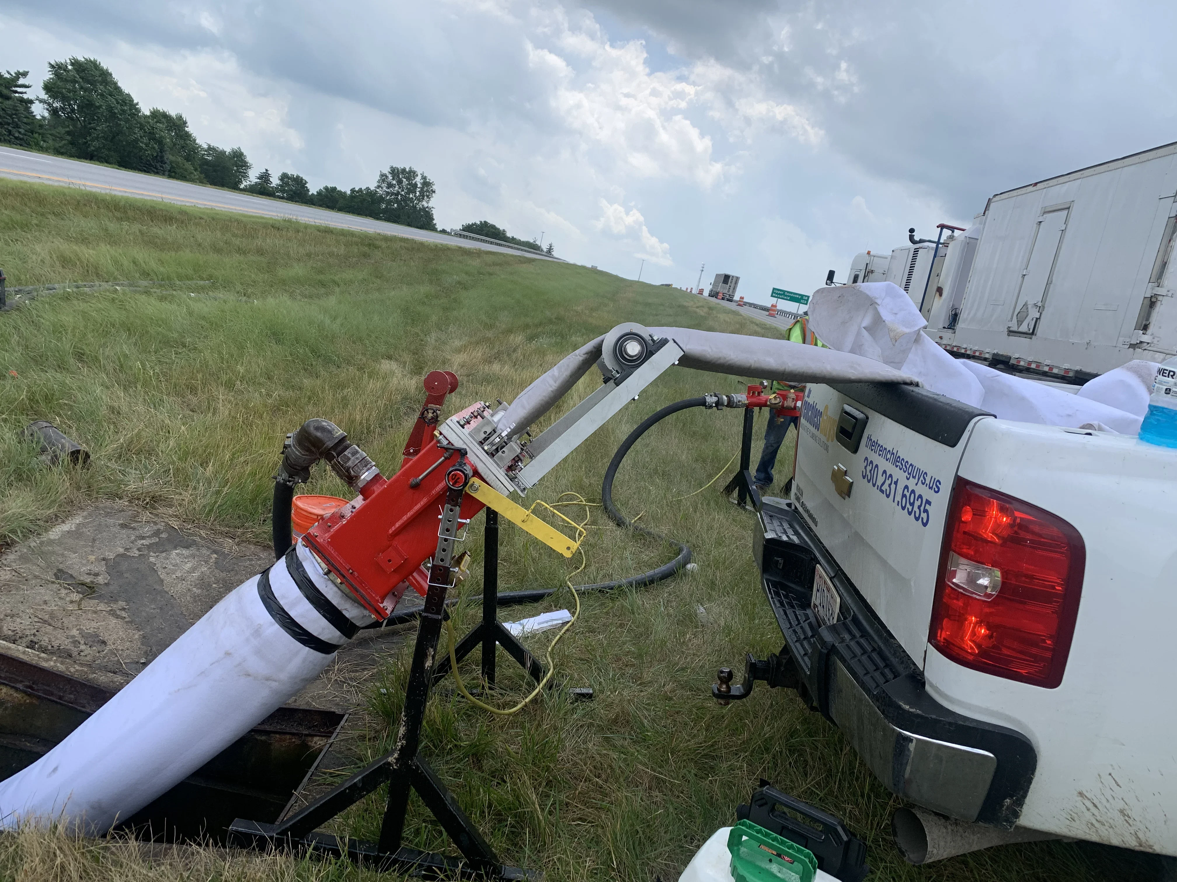 Trenchless pipe repair equipment and excavation machinery on residential property in Wooster